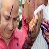 Delhi Deputy CM Manish Sisodia wipes ink off his face outside the LG house in New Delhi. Photo: PTI