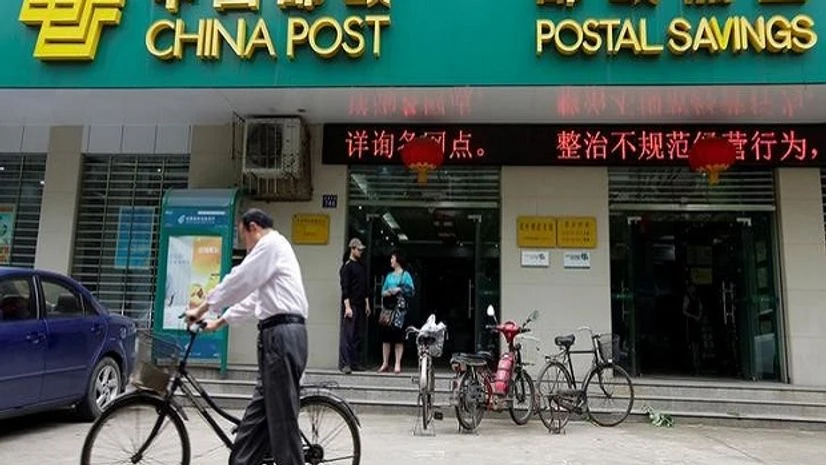 A man pushes his bicycle past a branch of China Post's Postal Savings Bank of China in Wuhan, Hubei province A man pushes his bicycle past a branch of China Post's Postal Savings Bank of China in Wuhan, Hubei province