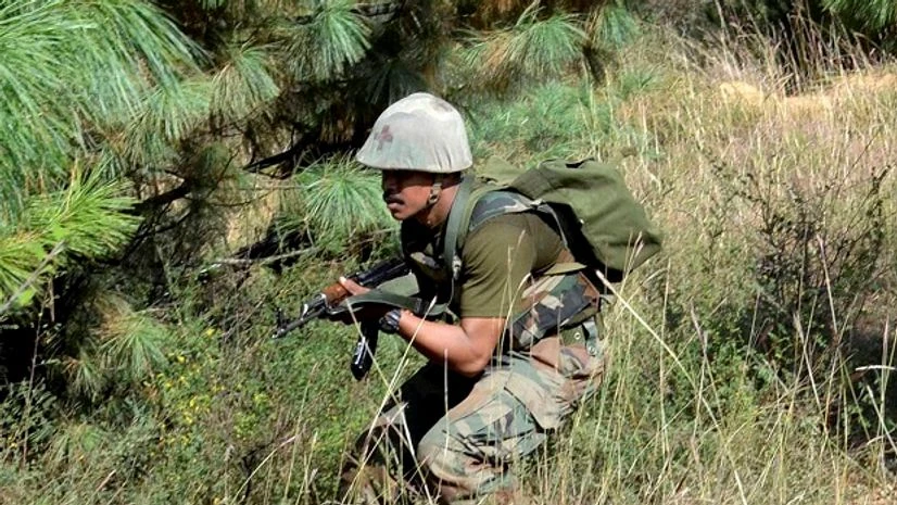 File photo: An army personnel takes position and moves towards the site where militants were hiding during an encounter at Lachipora in Uri Sector of north Kahsmir. Photo: PTI File photo: An army personnel takes position and moves towards the site where militants were hiding during an encounter at Lachipora in Uri Sector of north Kahsmir. Photo: PTI