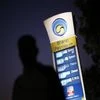 A Bharat Petroleum oil pump station displays the price of unleaded petrol (0.89$) and Diesel (0.66$) as a pedestrian walks past in New Delhi. Photo: Reuters