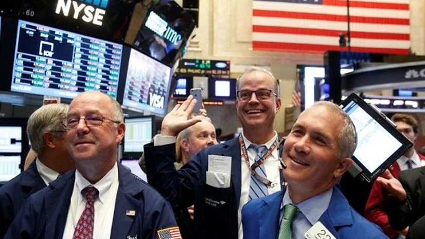 Traders react while working on the floor of the New York Stock Exchange (NYSE) in New York City Traders react while working on the floor of the New York Stock Exchange (NYSE) in New York City