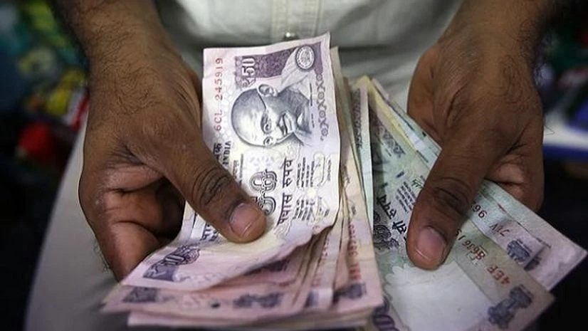 A private money trader counts rupees at a shop in Mumbai. Photo:Reuters A private money trader counts rupees at a shop in Mumbai. Photo:Reuters