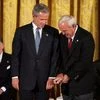 Recipient of the Presidential Medal of Freedom Arnold Palmer compares golf grips with then President George W Bush before receiving his award in the East Room of the White House on June 23, 2004 (Image: Wikipedia)