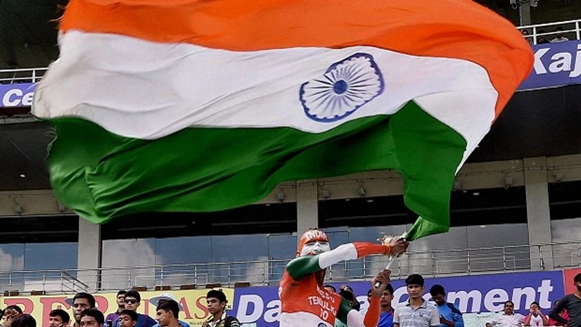 An Indian fan waving Tricolor flag in the gallery during 1st day of 2nd Test match between India and New Zealand at Eden Gardens in Kolkata. An Indian fan waving Tricolor flag in the gallery during 1st day of 2nd Test match between India and New Zealand at Eden Gardens in Kolkata.
