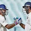 Indian batsman Cheteswar Pujara is greeted by Ajinkya Rahane (L) for his half century during 1st day of 2nd Test Match against New Zealand at Eden Garden in Kolkata. Photo:PTI