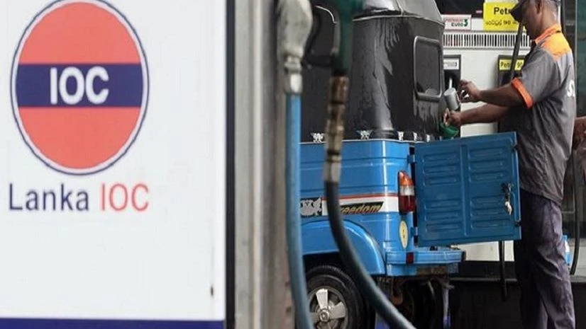 A worker fills the tank of a motorised vehicle, known locally as a "three-wheeler", at a Lanka India Oil fuel station in Colombo. Photo: Reuters A worker fills the tank of a motorised vehicle, known locally as a "three-wheeler", at a Lanka India Oil fuel station in Colombo. Photo: Reuters