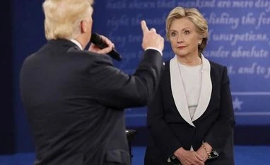 Wikileaks colluding with Russia to help Trump: Clinton campaign Democratic presidential candidate Hillary Clinton listens to Republican counterpart Donald Trump at Washington University in St Louis, Missouri. (Reuters)