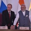 Russian President Vladimir Putin (L) shakes handS with India's Prime Minister Narendra Modi during a photo opportunity ahead of India-Russia Annual Summit in Benaulim, in Goa