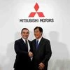 Carlos Ghosn (L), Chairman and CEO of the Renault-Nissan Alliance and Mitsubishi Motors Corp's Chairman and CEO Osamu Masuko attend their joint news conference in Tokyo