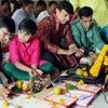 Indian businessmen sit beside their accounts books and electronic gazette  as part of a ritual to worship the Hindu deity of wealth Goddess Lakshmi on Diwali in Ahmedabad.