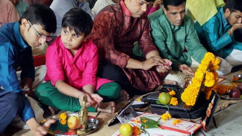 Indian businessmen sit beside their accounts books and electronic gazette as part of a ritual to worship the Hindu deity of wealth Goddess Lakshmi on Diwali in Ahmedabad. Indian businessmen sit beside their accounts books and electronic gazette as part of a ritual to worship the Hindu deity of wealth Goddess Lakshmi on Diwali in Ahmedabad.