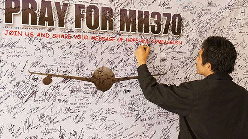 A man writes messages and prayers for Malaysia Airlines Boeing 777-200ER MH370 in IIUM Library, Kuantan Pahang, Malaysia. (Photo: Shutterstock) A man writes messages and prayers for Malaysia Airlines Boeing 777-200ER MH370 in IIUM Library, Kuantan Pahang, Malaysia. (Photo: Shutterstock)