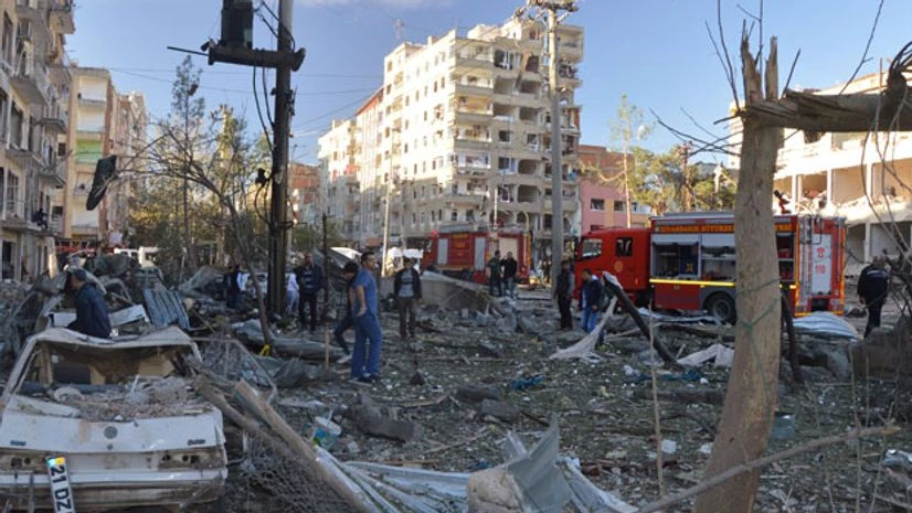 Damaged cars are seen on a street after a blast in Diyarbakir, Turkey Damaged cars are seen on a street after a blast in Diyarbakir, Turkey