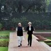 Prime Minister Narendra Modi walks with his UK counterpart Theresa May in lawns of Hyderabad House before a meeting in New Delhi.Photo: PTI