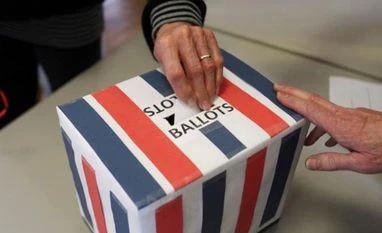 US Election 2016: Voting at first polling stations begins US Election 2016: A voter casts a ballot during the Harpswell republican town caucus at the Old Orr's Island (Photo - Reuters)