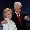 Democratic presidential nominee Hillary Clinton stands with her husband Bill Clinton (Reuters)