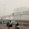 People commute in dense smog in Gurugram