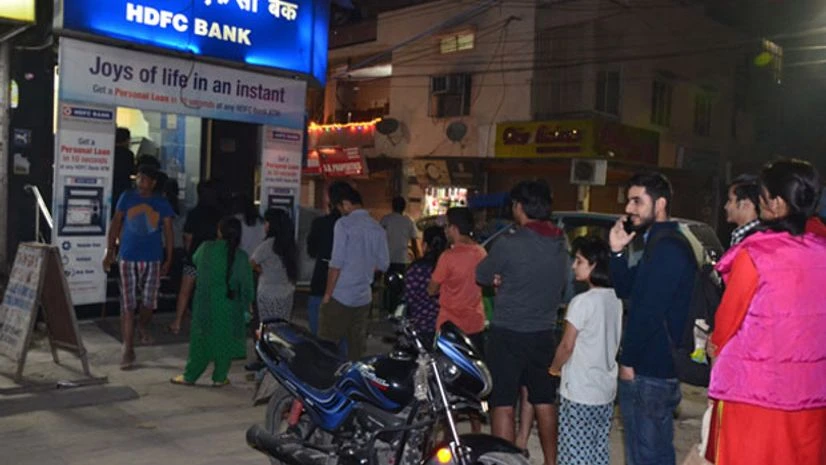People withdrawing money from atms People withdrawing money from atms