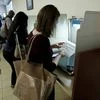 Kaitlin Harr looks over her ballot envelope before sealing it and depositing it in the ballot box at the Sacramento County Registrar of Voters office in Sacramento, California. (Photo: AP/PTI)