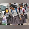 Ministry reviews guidelines for implementation of bagless days in schools School children wear anti-air pollution mask as a protective gear in Gurugram. (Photo: PTI)