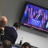 Traders at BGC Partners look at screens as victorious US Presidential election candidate Donald Trump speaks on a television screen behind, in London (Reuters)