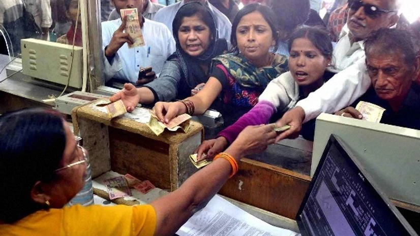 Passengers gives 500 rupees for train ticket at a booking window Passengers gives 500 rupees for train ticket at a booking window
