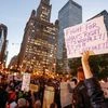 A protester holds a sign during a protest against Republican president-elect Donald Trump outside Trump International Hotel and Tower in Chicago, Illinois