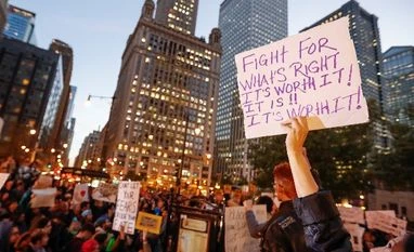 Twitter flooded with Donald Trump's 'assassination' posts A protester holds a sign during a protest against Republican president-elect Donald Trump outside Trump International Hotel and Tower in Chicago, Illinois