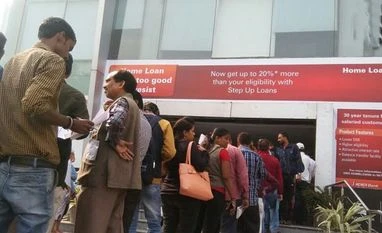Mayhem captured in photos: ATMs go dry after opening; queues get bigger People wait to deposit and withdraw their money outside banks and ATMs