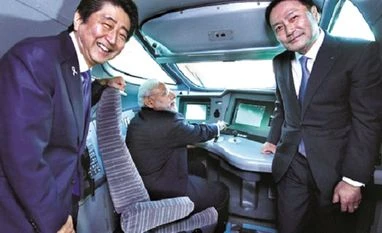 PM warns of more action to unearth black money Prime Minister Narendra Modi on the pilot seat of a bullet train with his Japanese counterpart Shinzo Abe (left) and Kawasaki Heavy Industries (KHI) President, Yoshinori Kanehana during his visit to KHI Hyogo Plant in Kobe on Saturday. Photo: PTI