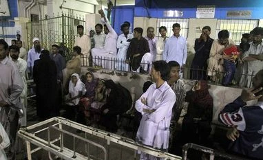 52 killed in sufi shrine blast in Pak's Balochistan People gather outside an emergency ward of a local hospital after hearing news of a bomb blast at a Sufi shrine, in Karachi, Pakistan, Saturday, November 12, 2016 (Source: PTI)