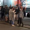 People stand in Tory Street after being evacuated from buildings in Wellington after a 6.6 earthquake based around Cheviot in the South island shock the capital, New Zealand