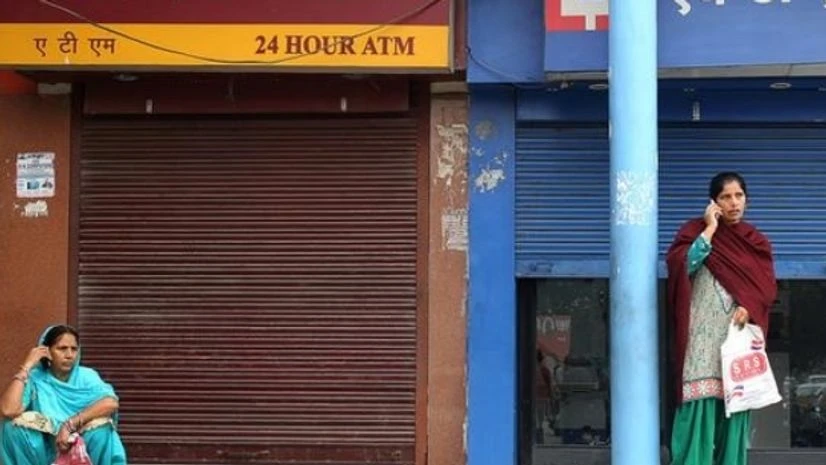 Women wait for ATM counters to open in Jammu Women wait for ATM counters to open in Jammu