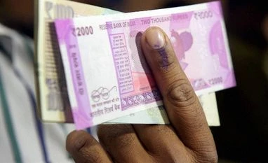 Rajya Sabha MP writes to NHRC on demonetisation A man shows his inked finger and exchanged currency notes at a SBI branch in New Delhi