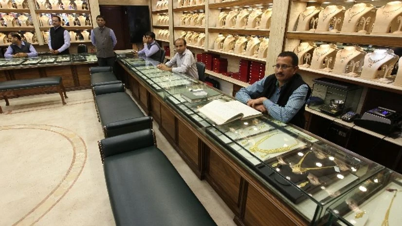 Sales persons wait for customers at a gold jewelry showroom in Chandigarh Sales persons wait for customers at a gold jewelry showroom in Chandigarh