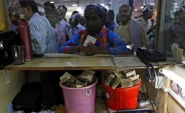 Imphal: Bank security beats up journalist for doing his job Old high denomination bank notes are seen kept in buckets at a counter as people stand in a queue to deposit their money inside a bank in the northern city of Kanpur