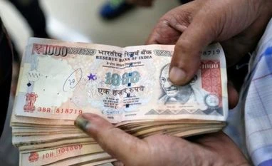 19.1 bn new notes pumped into public domain: RBI A customer waits to deposit 1000 Indian rupee banknotes in a cash deposit machine at bank in Mumbai