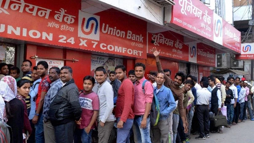 People stand in a long queue to withdraw money at an ATM in Allahabad People stand in a long queue to withdraw money at an ATM in Allahabad