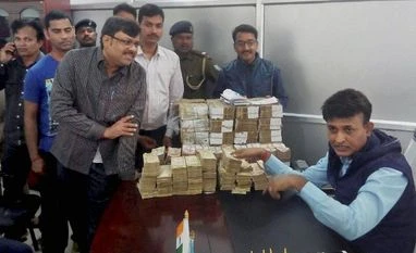 Suspect cash: I-T Dept warns violators will face seven years in jail Police officials showing Rs 45 Lakhs recovered from a postal employee's residence during a raid in Dumka of Jharkhand