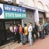 Line of discontent: People queue outside an ATM of State Bank of India to withdraw money in Kolkata