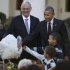 President Barack Obama, with his nephews Aaron Robinson, front, and Austin Robinson and National Turkey Federation Chairman John Reicks, pardons the National Thanksgiving Turkey, Tot
