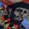 Roses placed by members of Mexico's communist party lay atop an image of late Cuban President Fidel Castro, outside the Cuban Embassy in Mexico City.
