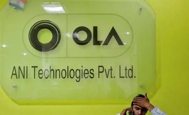 Ola partners Google to show outstation cabs in maps An employee speaks over his phone as he sits at the front desk inside the office of Ola cab service in Gurugram (Photo: Reuters)