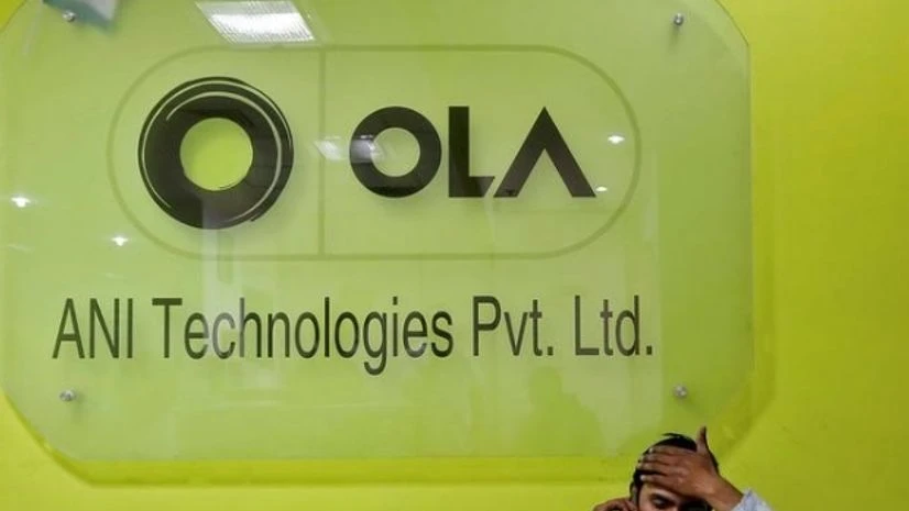 An employee speaks over his phone as he sits at the front desk inside the office of Ola cab service in Gurugram (Photo: Reuters) An employee speaks over his phone as he sits at the front desk inside the office of Ola cab service in Gurugram (Photo: Reuters)