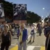 Mourners hold pictures of Fidel Castro as they wait to pay their last respects to the late leader at Revolution Plaza in Havana, Cuba