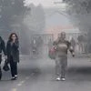 Passengers walk on a cold foggy morning at the New Delhi Railway Station in New Delhi. Photo: PTI