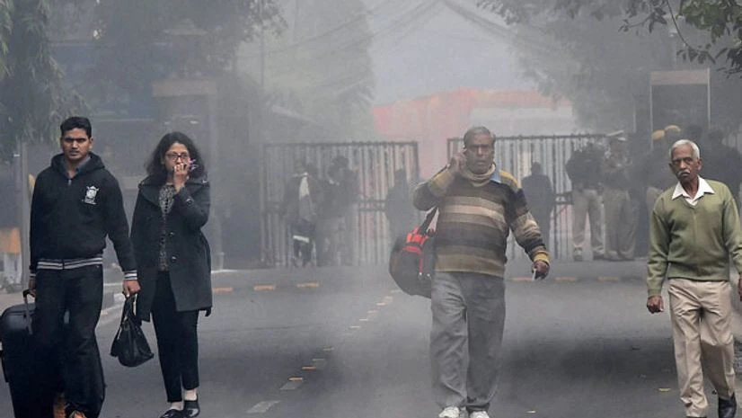 Passengers walk on a cold foggy morning at the New Delhi Railway Station in New Delhi. Photo: PTI Passengers walk on a cold foggy morning at the New Delhi Railway Station in New Delhi. Photo: PTI