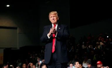 Donald Trump says, 'I don't want China dictating to me' US President-elect Donald Trump claps at the USA Thank You Tour event at the Iowa Events Center in Des Moines, Iowa, US