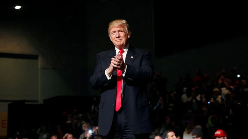 US President-elect Donald Trump claps at the USA Thank You Tour event at the Iowa Events Center in Des Moines, Iowa, US US President-elect Donald Trump claps at the USA Thank You Tour event at the Iowa Events Center in Des Moines, Iowa, US