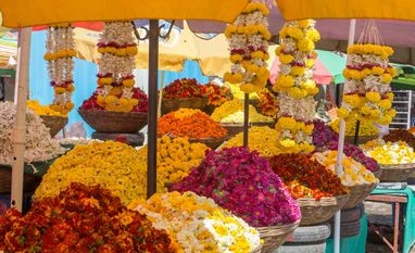 Post-demonetisation: Flower farmers' income falls by 70% Colorful flower stall in a street market, with garlands and baskets of flowers. Photo: Shutterstock